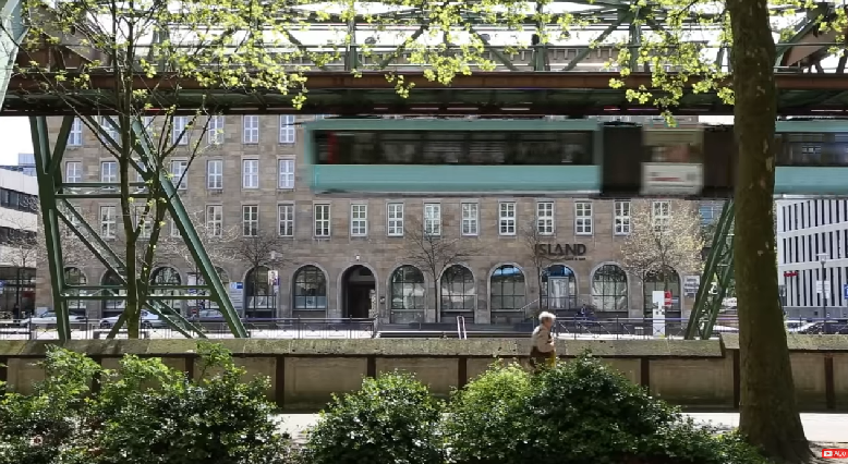 Quiet overehead rail, in sympathy with scenery and pedestrian traffic.